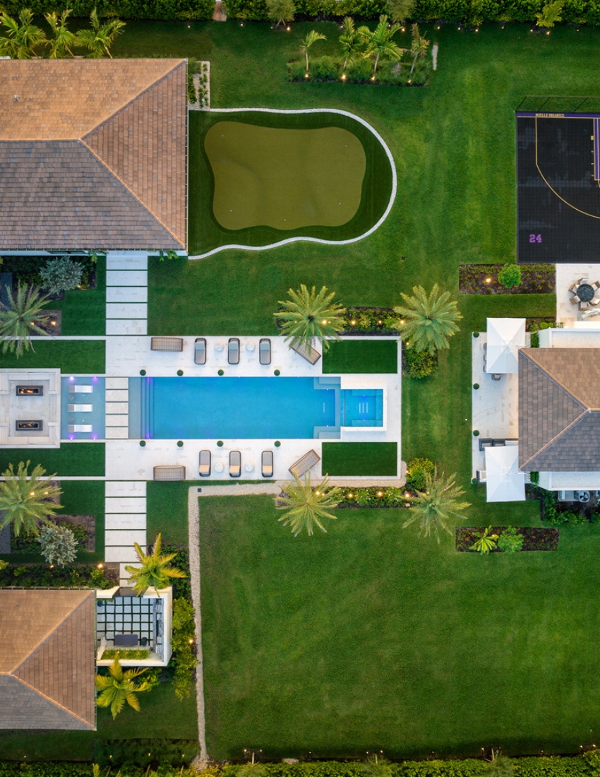 Aerial shot of a modern house with a sparkling pool, offering a serene and luxurious living experience