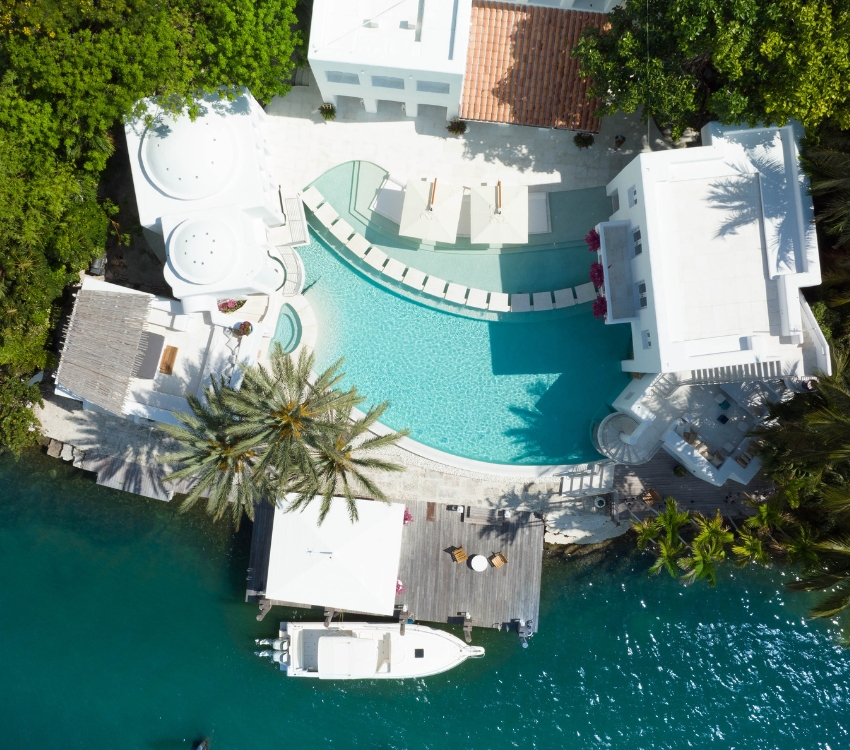 Aerial view of a luxurious resort with a sparkling pool, offering a breathtaking escape